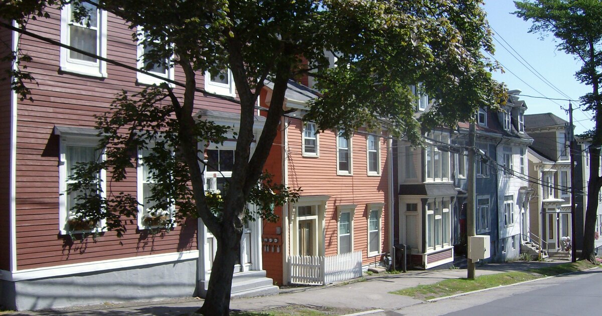 Older wood-frame multi-unit houses on a Saint John, New Brunswick street